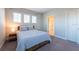 Bright bedroom featuring plush carpet, three bright windows, and a neutral color scheme at 11966 Climbing Fern Ave, Riverview, FL 33579