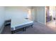Bedroom with plush carpet and access to bathroom and hallway through paneled doors at 11966 Climbing Fern Ave, Riverview, FL 33579