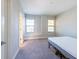 Bedroom featuring plush carpeting and natural light from the two windows with blinds at 11966 Climbing Fern Ave, Riverview, FL 33579