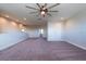 Large upstairs bonus room with carpet and ceiling fan with a great view of the house at 11966 Climbing Fern Ave, Riverview, FL 33579