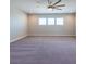Spacious bonus room featuring plush carpeting, neutral walls, and a modern ceiling fan at 11966 Climbing Fern Ave, Riverview, FL 33579