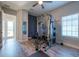 Well-equipped home gym with weight machine and plank flooring at 11966 Climbing Fern Ave, Riverview, FL 33579