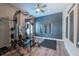 Spacious home gym with weight machine, free weights, and plank flooring at 11966 Climbing Fern Ave, Riverview, FL 33579