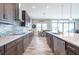 Bright kitchen with wood floors, a modern backsplash, and a stainless steel dishwasher at 11966 Climbing Fern Ave, Riverview, FL 33579