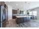 Spacious kitchen features a large island, stainless steel appliances, and a modern tile backsplash at 11966 Climbing Fern Ave, Riverview, FL 33579
