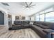 Open-concept living space with tile flooring, modern lighting, and comfortable seating, adjacent to the kitchen at 11966 Climbing Fern Ave, Riverview, FL 33579