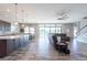Open-concept living room and kitchen with tile floors, stainless steel appliances, and access to the backyard at 11966 Climbing Fern Ave, Riverview, FL 33579