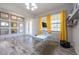 Modern office featuring a gray accent wall and a glass desk at 11966 Climbing Fern Ave, Riverview, FL 33579