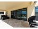 Covered patio with large sliding doors, offering a seamless transition to the outdoor pool area at 11966 Climbing Fern Ave, Riverview, FL 33579