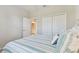Comfortable bedroom with a neutral palette and a view to the en-suite bathroom and closet at 12379 Amica Loop, Venice, FL 34293