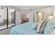 Well-lit bedroom leading to a living room and bathroom, with sliding door to private patio at 12379 Amica Loop, Venice, FL 34293