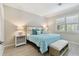 Bright bedroom featuring a stylish bed with blue accents, complemented by elegant white bedside tables at 12379 Amica Loop, Venice, FL 34293