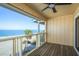Enjoy tranquil views from this balcony overlooking a pristine beach and ocean, complete with a cooling ceiling fan at 12512 1St W St # 2, Treasure Island, FL 33706