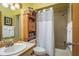 Bathroom with a single sink vanity, shower, and adjacent toilet and storage at 12512 1St W St # 2, Treasure Island, FL 33706