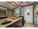 Elegant bathroom with dual sinks, luxurious countertop, and a modern glass-enclosed shower, combining style with functionality at 12512 1St W St # 2, Treasure Island, FL 33706