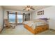 Cozy bedroom with ocean view balcony, ceiling fan, and ample storage under the bed, blending comfort and convenience at 12512 1St W St # 2, Treasure Island, FL 33706