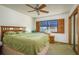 Comfortable bedroom featuring a large window with a view, ceiling fan, and wooden accents at 12512 1St W St # 2, Treasure Island, FL 33706