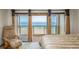 Inviting bedroom with a private balcony overlooking the ocean, offering serene beach views and a relaxing atmosphere at 12512 1St W St # 2, Treasure Island, FL 33706