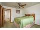 Cozy bedroom with a ceiling fan and a glimpse into an adjacent room, creating a comfortable and connected living space at 12512 1St W St # 2, Treasure Island, FL 33706