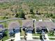 An aerial view shows the community with houses that have backyard fences and are next to a conservation area at 12841 Wildflower Meadow Dr, Riverview, FL 33579