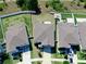 An aerial view shows rooftops, fenced backyards with patios, driveways with cars, and manicured front lawns at 12841 Wildflower Meadow Dr, Riverview, FL 33579