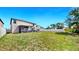 Expansive backyard with a well-maintained lawn and a screened patio for outdoor enjoyment at 12841 Wildflower Meadow Dr, Riverview, FL 33579