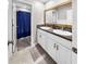 Bathroom featuring double sinks, granite countertops, modern hardware, and a separate shower area at 12841 Wildflower Meadow Dr, Riverview, FL 33579