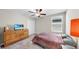 Bedroom featuring a wood dresser, television, carpet, ceiling fan, closet and window at 12841 Wildflower Meadow Dr, Riverview, FL 33579