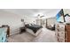 Large bedroom with bed, TV, chair, window and dresser offering an inviting space at 12841 Wildflower Meadow Dr, Riverview, FL 33579