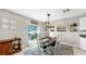 The dining area includes a view of the patio, table with seating for six, and 