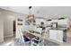 The dining area includes a view of the kitchen, table with seating for six, and a modern light fixture at 12841 Wildflower Meadow Dr, Riverview, FL 33579