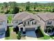 Two-story home showing an elevated perspective that highlights the roof and siding details, with a landscaped front yard at 12841 Wildflower Meadow Dr, Riverview, FL 33579