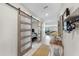 Inviting hallway features stylish barn doors with frosted glass panels, enhancing the interior's modern aesthetic at 12841 Wildflower Meadow Dr, Riverview, FL 33579