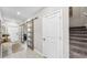 Bright hallway showcasing modern barn doors, leading to the staircase and various rooms in the house at 12841 Wildflower Meadow Dr, Riverview, FL 33579
