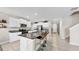 Modern kitchen features granite counters, stainless appliances, white cabinetry and a central island with seating at 12841 Wildflower Meadow Dr, Riverview, FL 33579