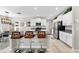 Bright kitchen features granite counters, white cabinets, stainless steel appliances, and an island with seating at 12841 Wildflower Meadow Dr, Riverview, FL 33579