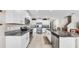 Bright, modern kitchen with stainless steel appliances, granite countertops, and white cabinets provides ample storage space at 12841 Wildflower Meadow Dr, Riverview, FL 33579