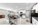Bright kitchen boasts granite counters, stainless appliances, white cabinetry, and an island with bar seating at 12841 Wildflower Meadow Dr, Riverview, FL 33579