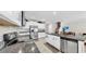 Modern kitchen features granite counters, stainless steel appliances, white cabinetry, and ample counter space at 12841 Wildflower Meadow Dr, Riverview, FL 33579