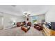 Comfortable living area with leather furnishings, a ceiling fan, and a large window providing natural light at 12841 Wildflower Meadow Dr, Riverview, FL 33579