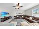 Bright living room features comfortable seating, neutral walls, and a ceiling fan for added comfort at 12841 Wildflower Meadow Dr, Riverview, FL 33579