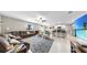 Open-concept living room boasts tile floors, ceiling fan, and flows into the kitchen with barstool seating at 12841 Wildflower Meadow Dr, Riverview, FL 33579