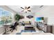 Functional home office with a work desk, a TV, and a comfortable sofa, ideal for remote work and relaxation at 12841 Wildflower Meadow Dr, Riverview, FL 33579