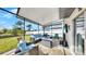 Inviting screened-in patio with comfortable seating, a modern fire pit, and outdoor television at 12841 Wildflower Meadow Dr, Riverview, FL 33579