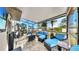 Relaxing screened patio featuring stylish furniture, a fire pit, and an outdoor view at 12841 Wildflower Meadow Dr, Riverview, FL 33579