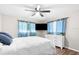 Bedroom featuring a ceiling fan, a mounted television, a bed and wood-look floors at 13501 Whitby Rd, Hudson, FL 34667