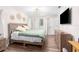 Light and airy bedroom featuring a bed, a tv, wood-look floors, and neutral walls at 13501 Whitby Rd, Hudson, FL 34667