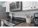 Stainless steel appliances, microwave, and black cooktop on marble backsplash walls at 13501 Whitby Rd, Hudson, FL 34667