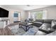 Spacious living room featuring a large sectional sofa and modern decor at 13501 Whitby Rd, Hudson, FL 34667