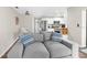 Comfortable living room that opens to a modern kitchen, featuring a cozy gray couch at 13501 Whitby Rd, Hudson, FL 34667